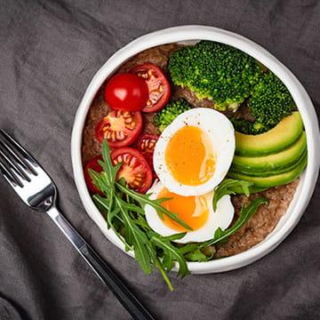 Balanced Meal Bowl With Egg, Avocado, Broccoli, and Tomatoes 