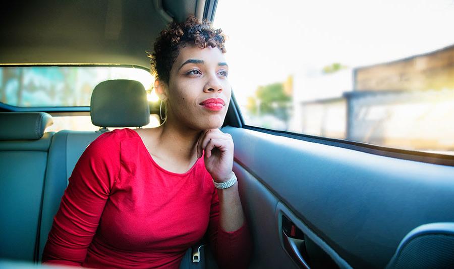 peaceful woman looks out car window